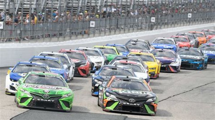 Who is singing the national anthem at the NASCAR race today?